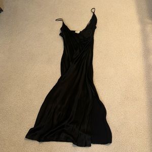 Black satin dress midi length with a slit and side ruching!